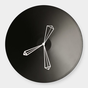 A black wall clock with minimalist geometric hands in white, featuring a modern design.