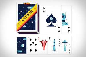 A deck of playing cards with a space-themed design labeled "Amigos." The cards feature illustrations of spaceships, rockets, and robots.